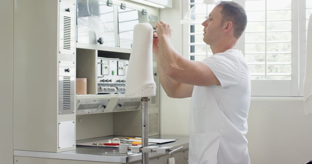 Technician Adjusting Prosthetic Component in Modern Lab