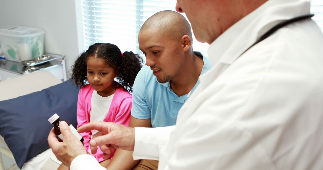 Doctor Explaining Prescription to Concerned Father and Daughter in Clinic - Free Images, Stock Photos and Pictures on Pikwizard.com