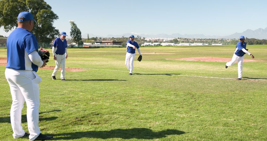 Baseball Team Practicing on Sunny Field for Teamwork and Athleticism