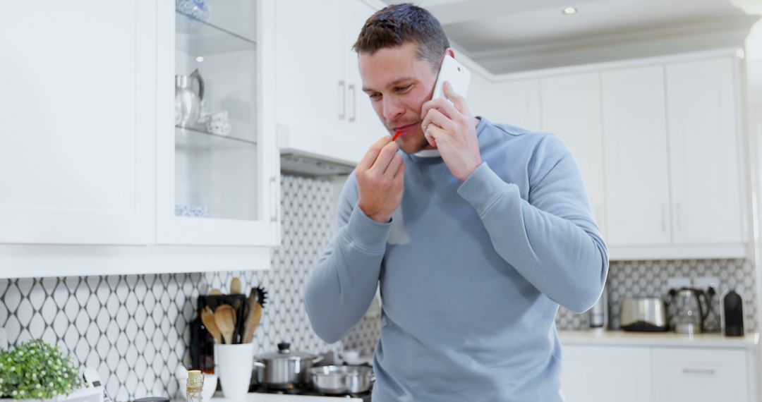 Man Balancing Work and Home Tasks in Modern Kitchen