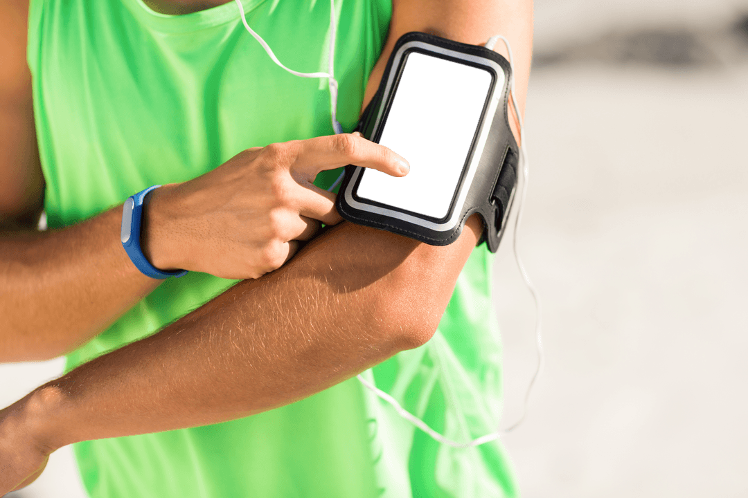Man Using Smartphone with Armband at Sunny Beach for Workout