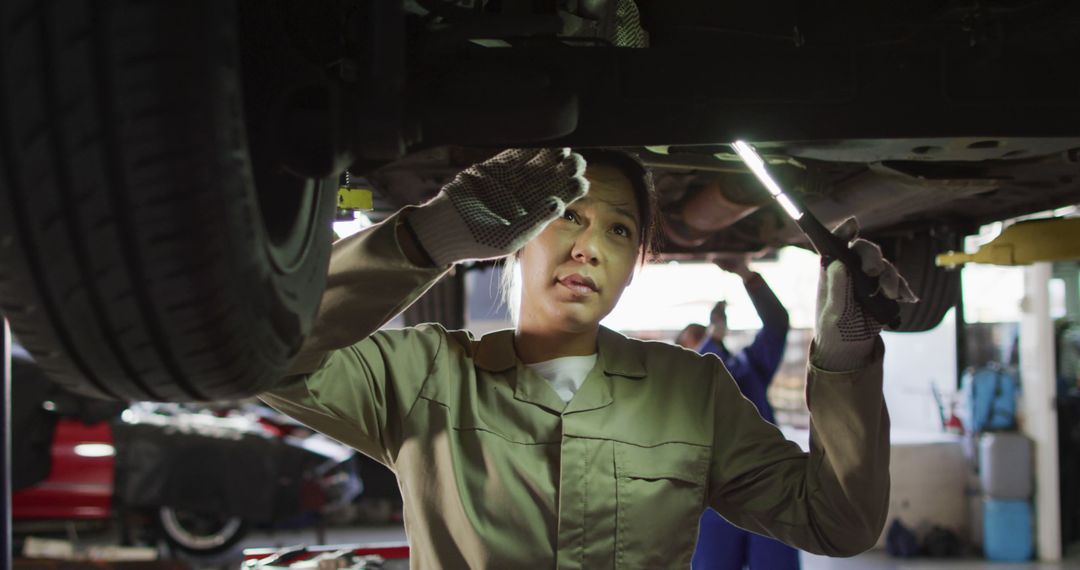 Female Mechanic Working Under Vehicle in Auto Repair Shop - Free Images, Stock Photos and Pictures on Pikwizard.com