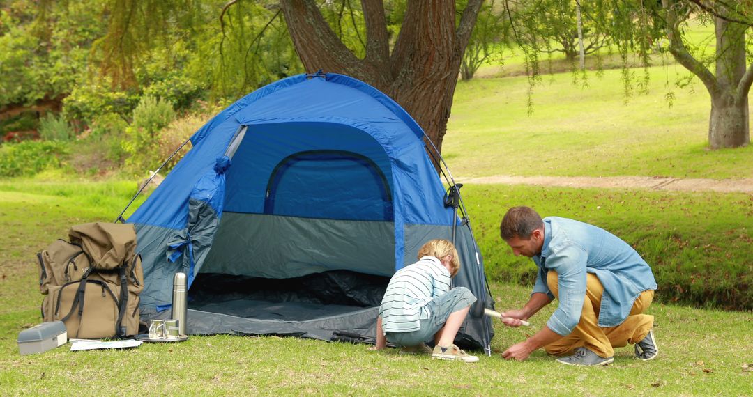 Father Setting Up Tent with Son in Sunny Park - Free Images, Stock Photos and Pictures on Pikwizard.com