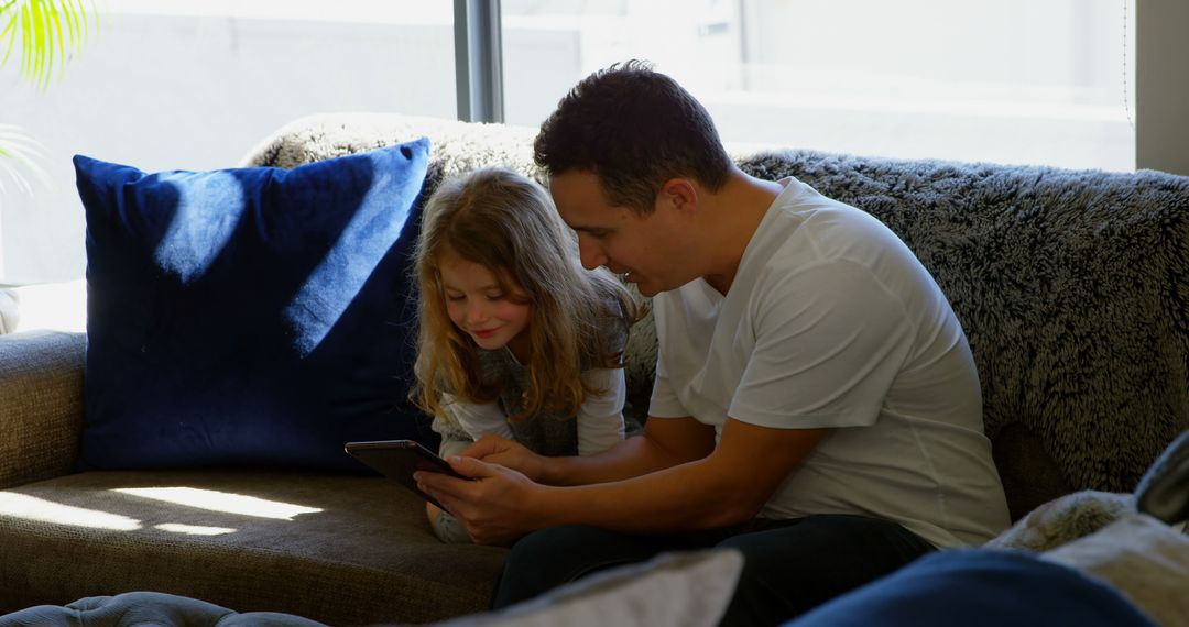 Father and Daughter Bonding over Tablet at Home - Free Images, Stock Photos and Pictures on Pikwizard.com