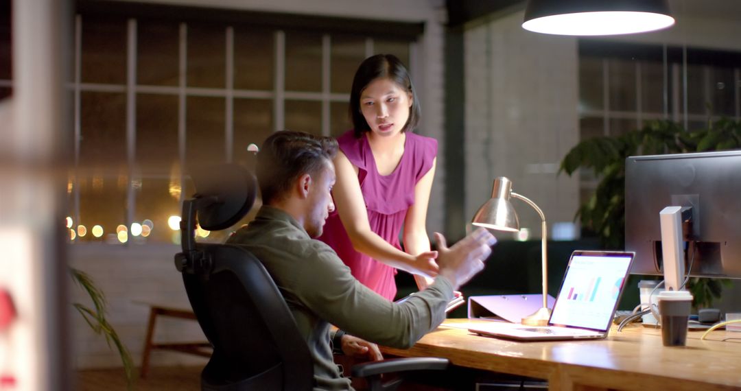 Focused Colleagues Collaborating on Tech Project Late at Night