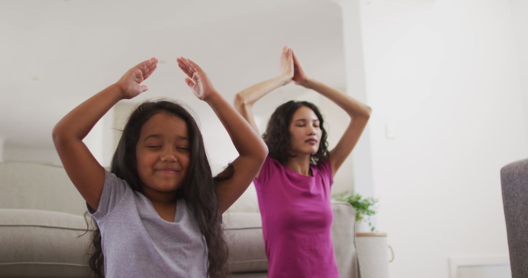 Hispanic Mother and Daughter Meditating at Home During Quarantine Lockdown - Free Images, Stock Photos and Pictures on Pikwizard.com