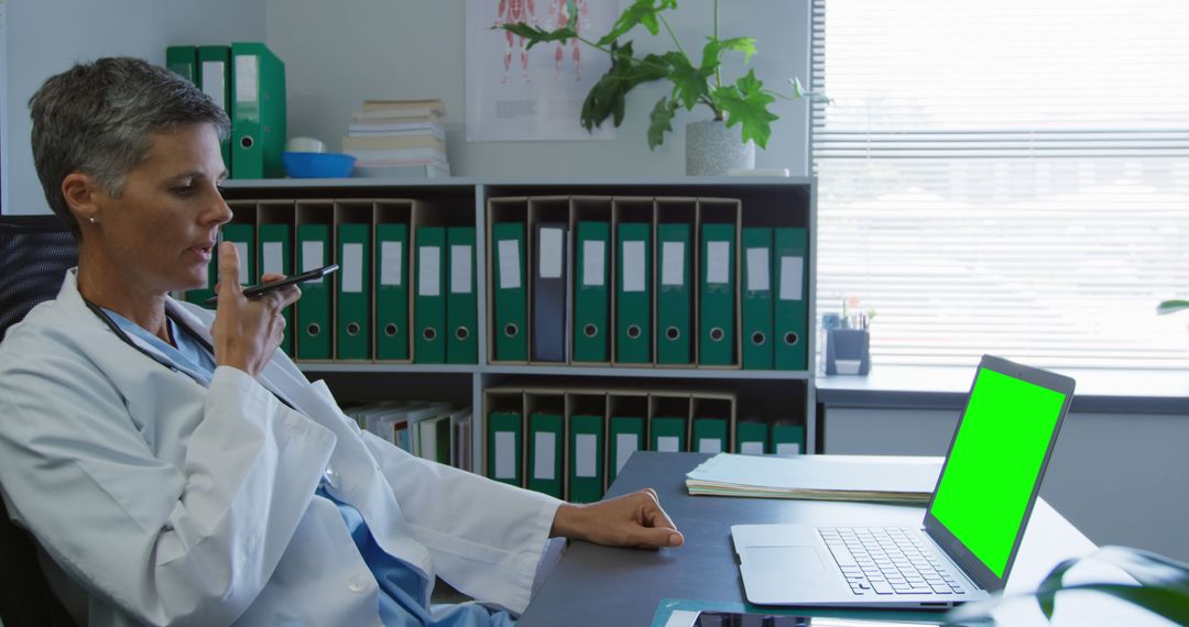 Female Doctor Dictating Notes with Smartphone in Office - Free Images, Stock Photos and Pictures on Pikwizard.com