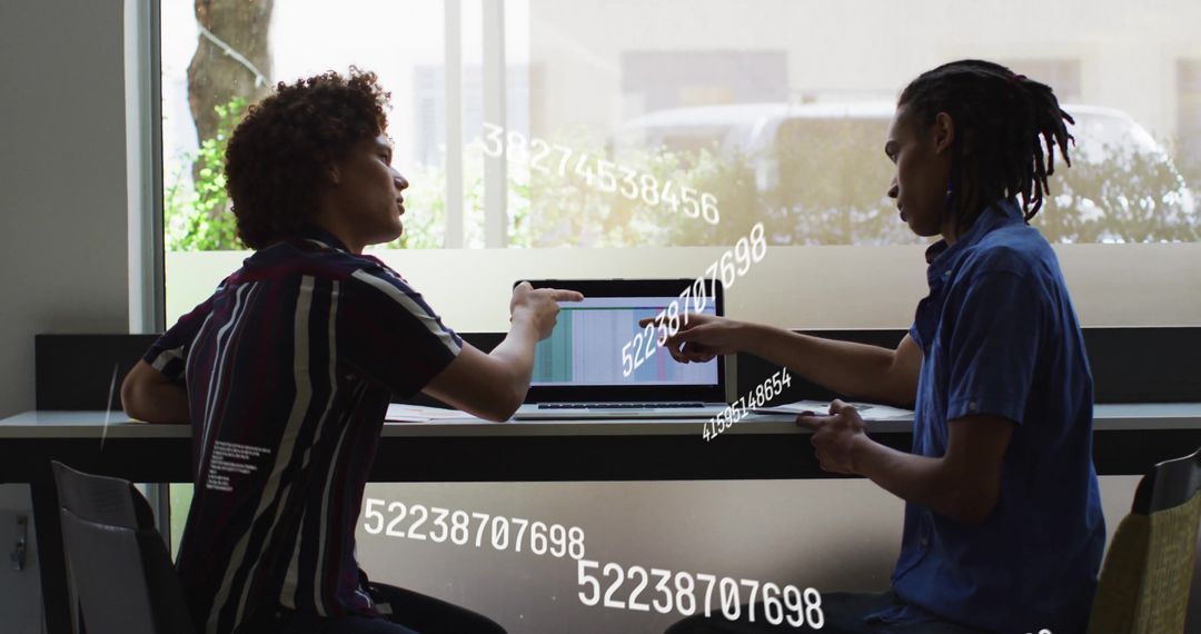 Collaborative Colleagues Analyzing Data with Laptop in Modern Café