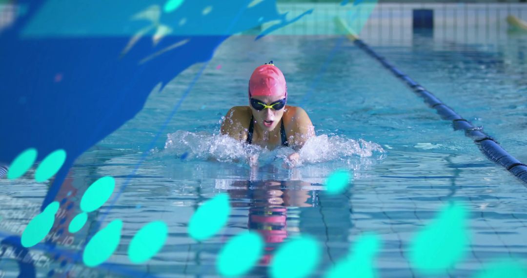 Female Swimmer Performing Powerful Breaststroke in Indoor Pool with Pink Cap and Goggles