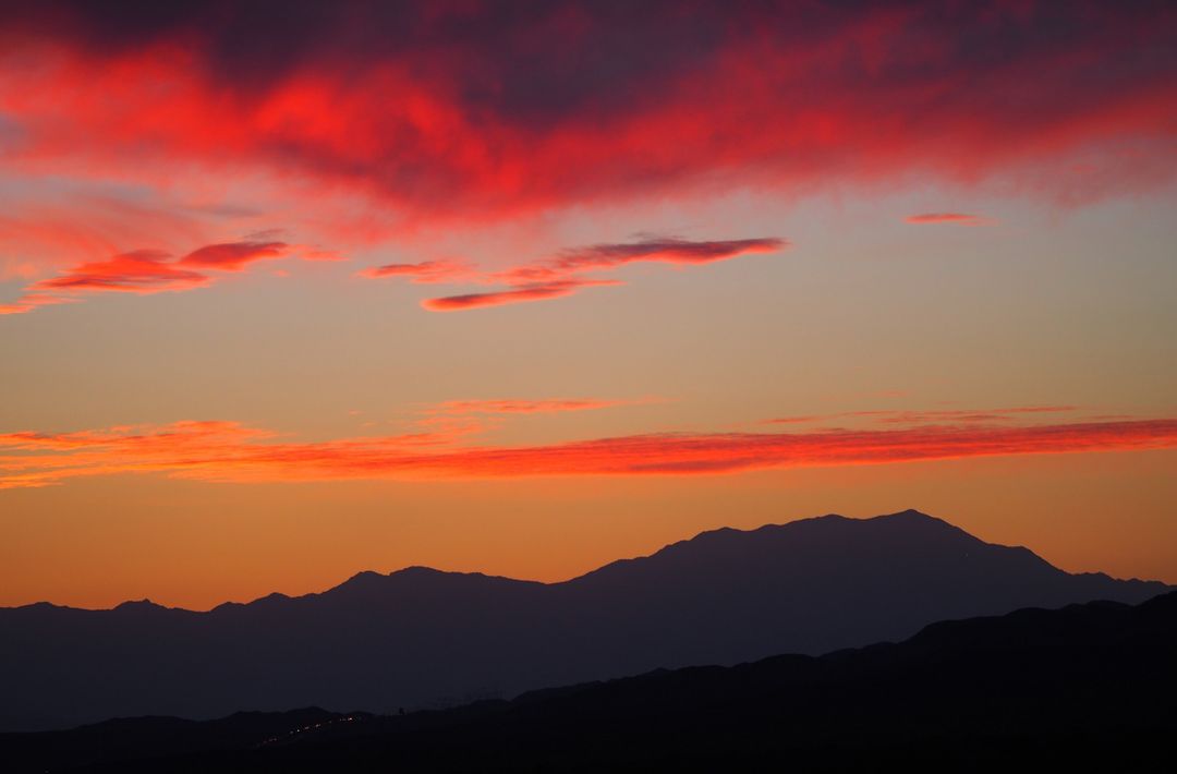 Vibrant Sunset Over Mountain Range with Red and Orange Sky - Free Images, Stock Photos and Pictures on Pikwizard.com