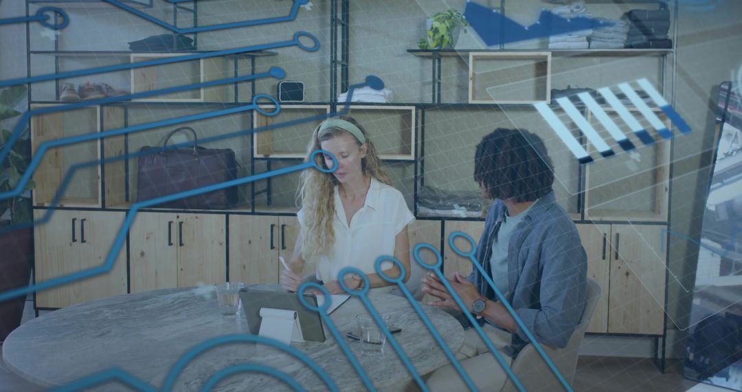 Creative team collaborating over tablet with digital circuit overlay for tech brainstorming