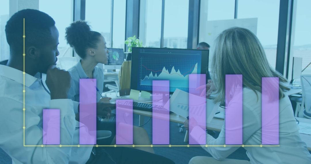 Diverse Team Analyzing Graphs and Business Data in Modern Office