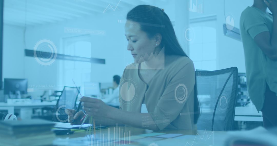 Asian Businesswoman Analyzing Innovative Digital Data in Modern Office