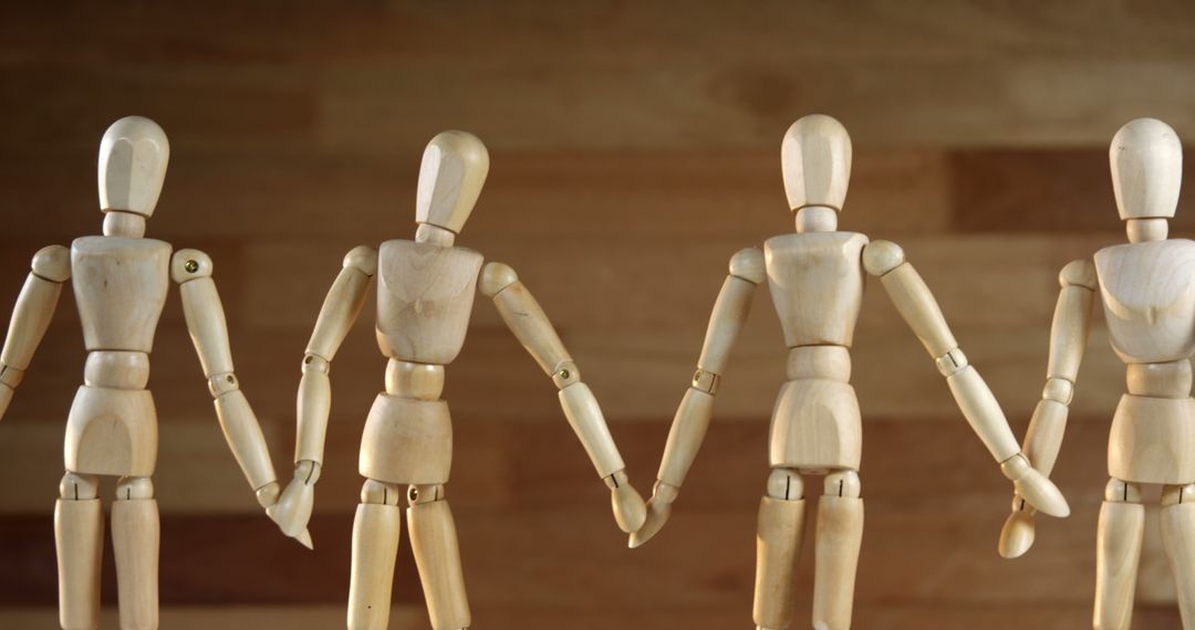 Group of Wooden Mannequins Holding Hands for Unity and Teamwork Concept - Free Images, Stock Photos and Pictures on Pikwizard.com