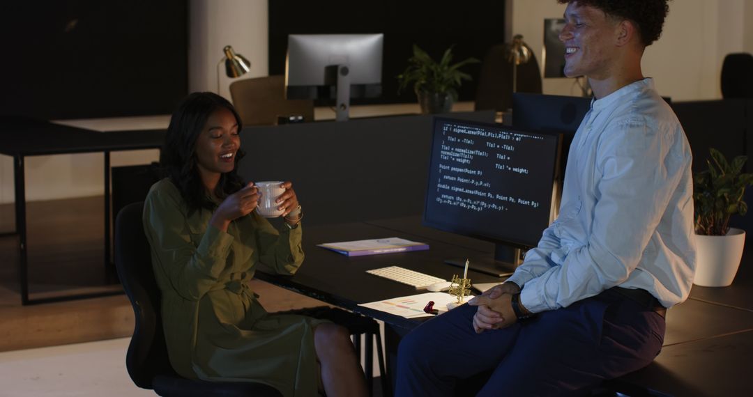 Professionals Collaborating Over Computer Code in Night Office