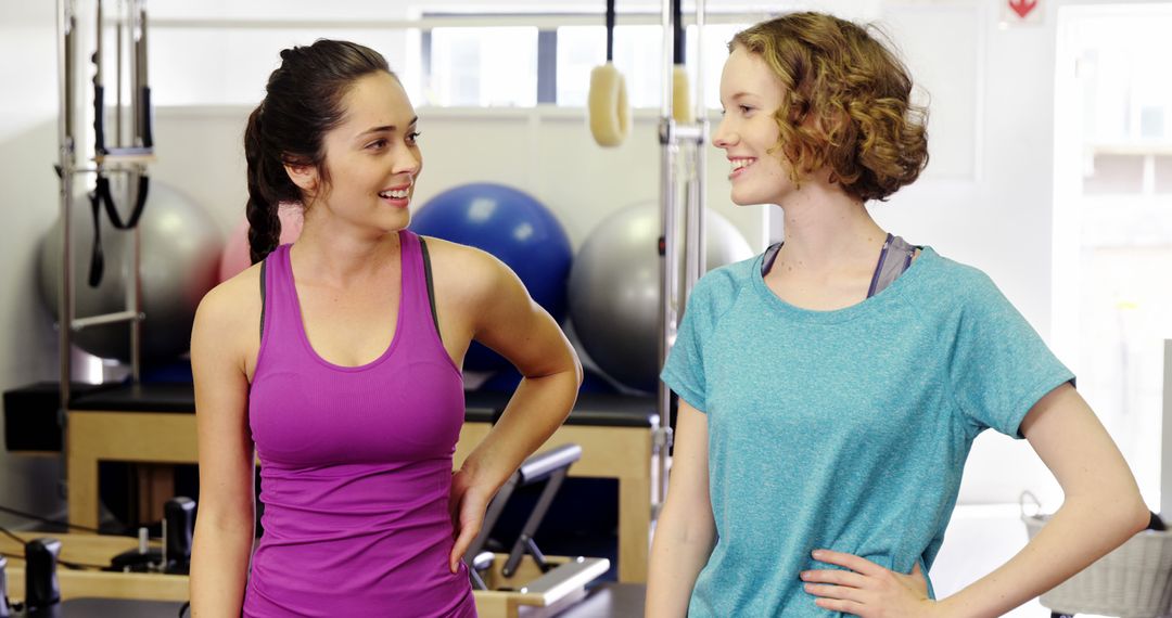 Two Women Chatting in Gym During Workout - Free Images, Stock Photos and Pictures on Pikwizard.com