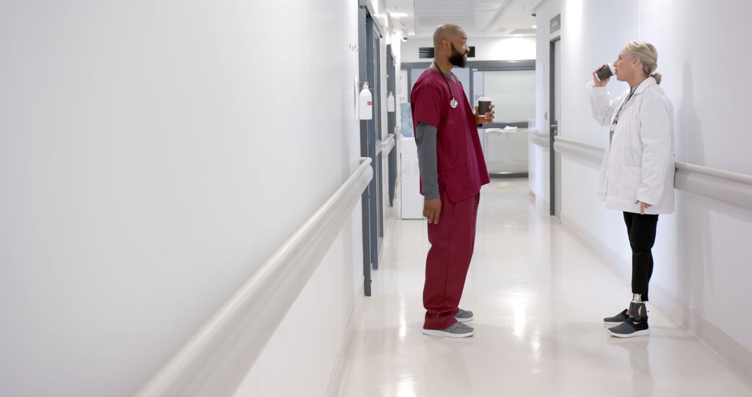 Medical Professionals Having Conversation in Hospital Hallway - Free Images, Stock Photos and Pictures on Pikwizard.com