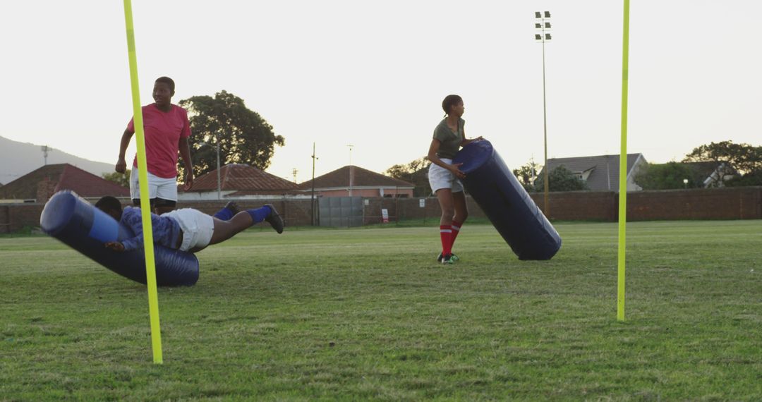 Rugby Players Practicing Tackling Drills Outdoors on Field - Free Images, Stock Photos and Pictures on Pikwizard.com