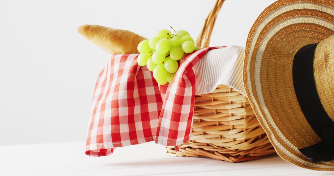 Picnic Basket with Bread, Green Grapes and Straw Hat on White Background - Free Images, Stock Photos and Pictures on Pikwizard.com