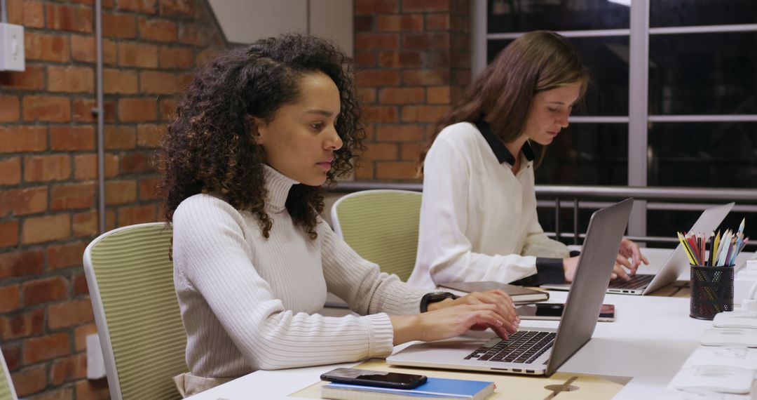 Diverse Women Working on Laptops in Modern Office - Free Images, Stock Photos and Pictures on Pikwizard.com