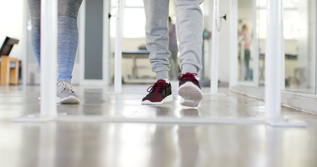 Rehabilitation Exercise with Therapist on Parallel Bars