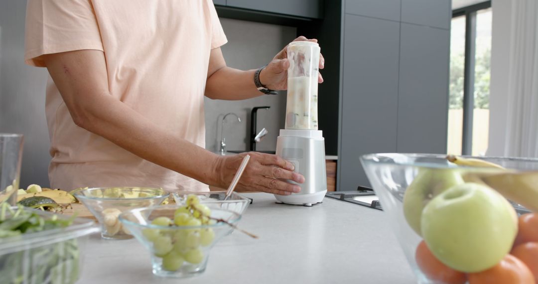 Person Preparing Smoothie in Modern Kitchen with Fresh Fruits - Free Images, Stock Photos and Pictures on Pikwizard.com