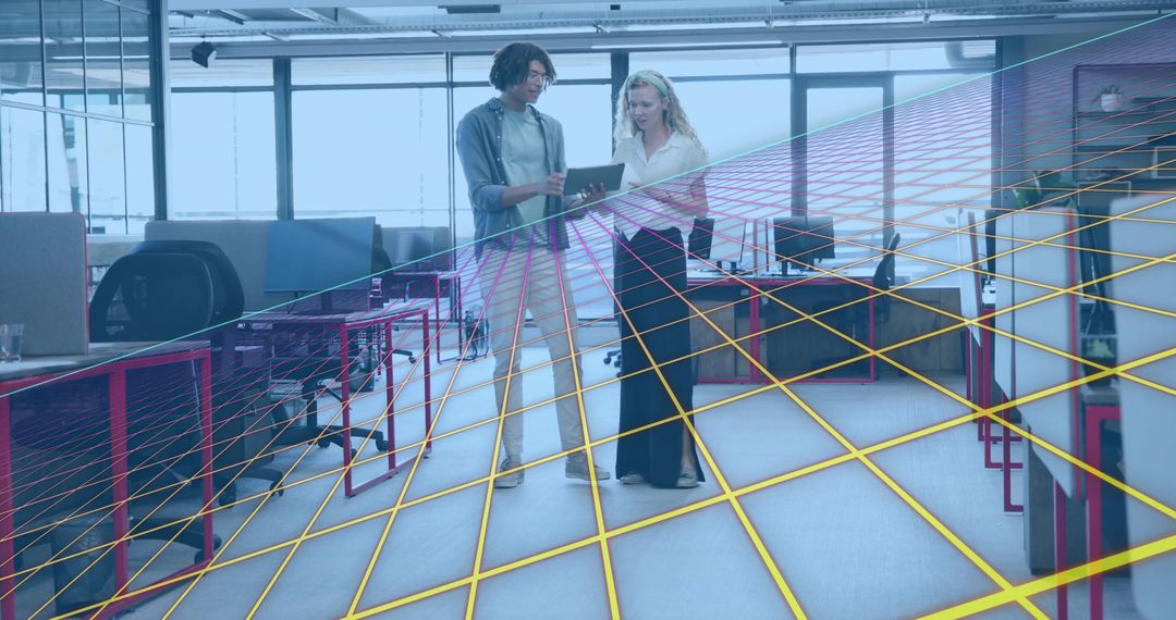 Coworkers reviewing tablet in modern open office using augmented wireframe overlay