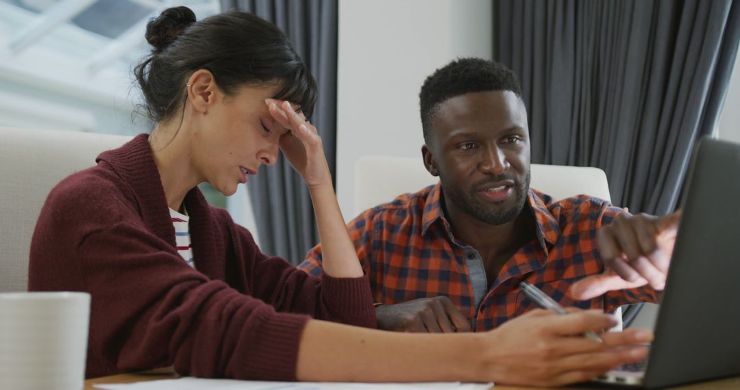 Couple Collaborating at Home Using Laptop