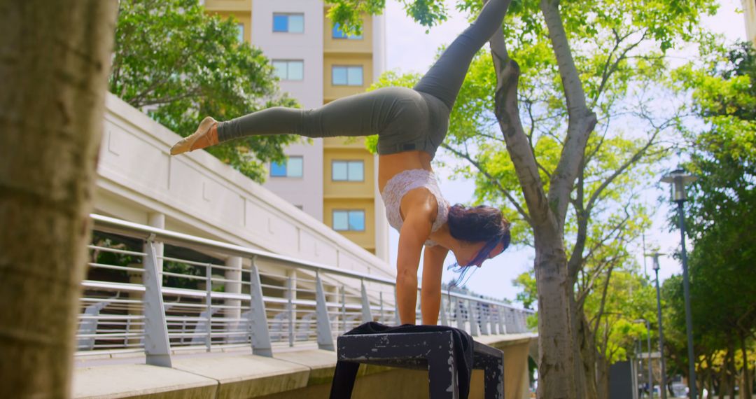 Athletic Woman Performing Handstand Outdoors with Urban Background - Free Images, Stock Photos and Pictures on Pikwizard.com