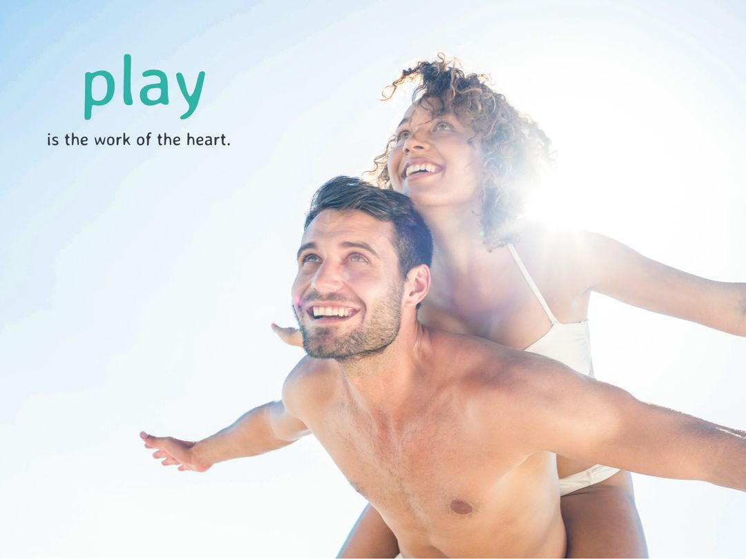 Joyful Couple Enjoying Beach Fun Under Sunlight