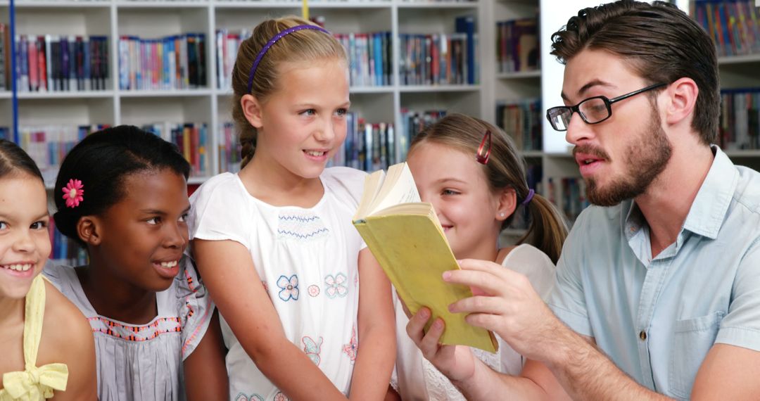 Teacher Reading Book to Engaged Young Students in Library - Free Images, Stock Photos and Pictures on Pikwizard.com