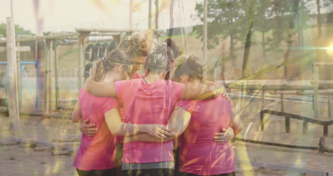 Diverse Women Embracing on Obstacle Course with Overlay