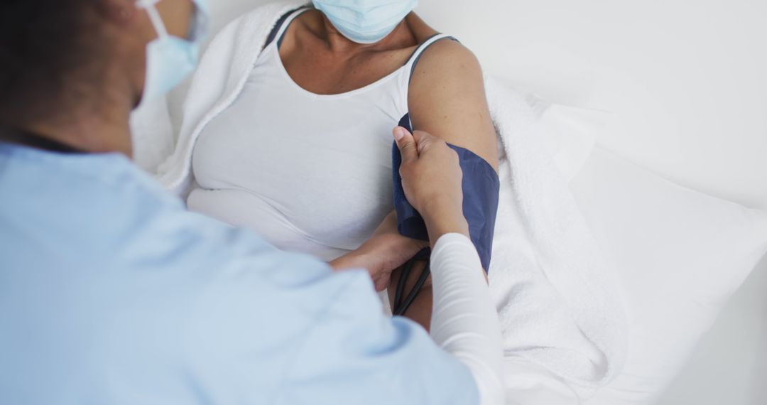 Nurse Measuring Blood Pressure for Female Patient Wearing Mask - Free Images, Stock Photos and Pictures on Pikwizard.com