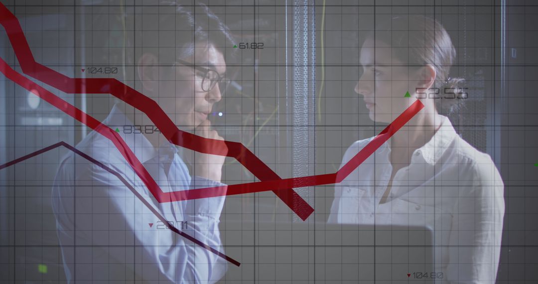 IT Engineers Analyzing Data Trends Amidst Servers