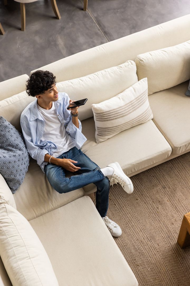 Man Enjoying Phone Call in Comfortable Living Room
