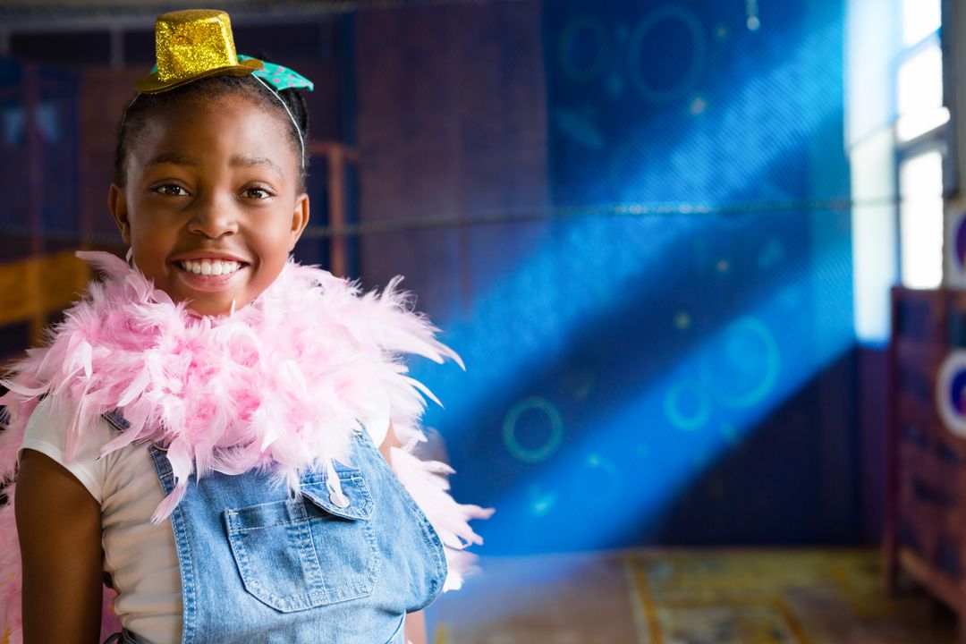 Joyful Girl in Costume Boasting Pink Feather Boa and Sparkly Hat