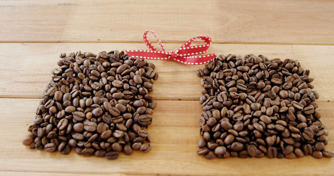 Creative Coffee Bean Gift with Red Ribbon on Wooden Table - Free Images, Stock Photos and Pictures on Pikwizard.com