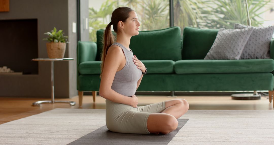 Woman Practices Breathing Exercise in Tranquil Home Living Room