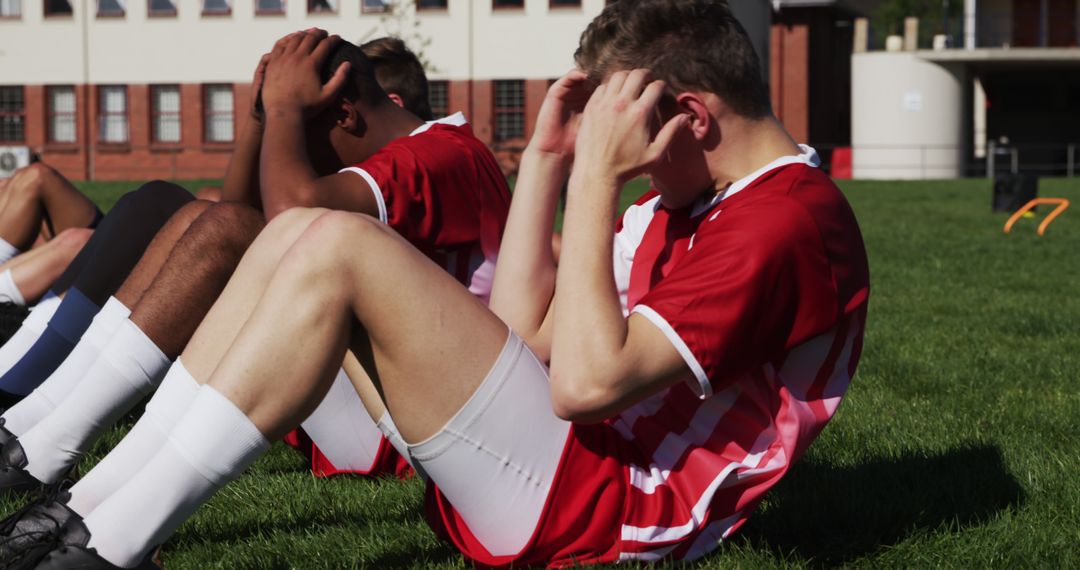 Young Soccer Players Doing Sit-Ups During Outdoor Training - Free Images, Stock Photos and Pictures on Pikwizard.com