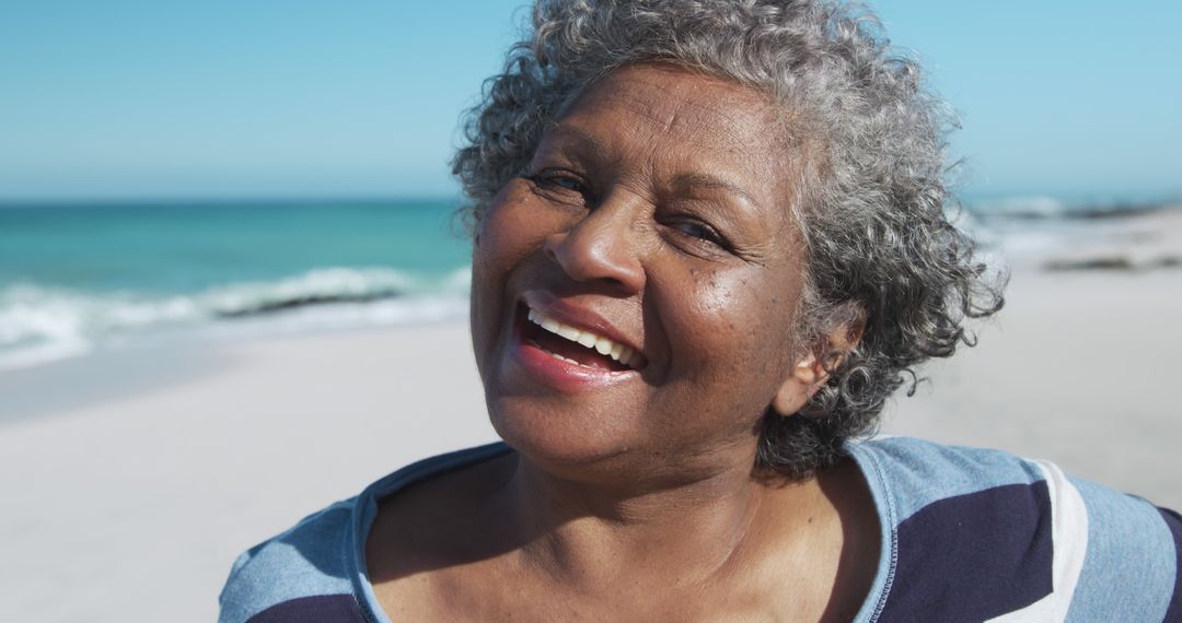 Happy Senior Woman Smiling on Beach - Free Images, Stock Photos and Pictures on Pikwizard.com