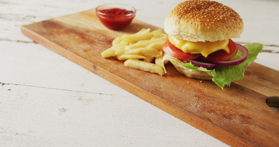 Classic Cheeseburger with Fries on Wooden Board - Free Images, Stock Photos and Pictures on Pikwizard.com