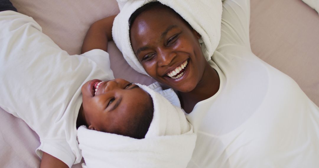 Happy African American Mother and Child with Towel Wrapped Hair - Free Images, Stock Photos and Pictures on Pikwizard.com