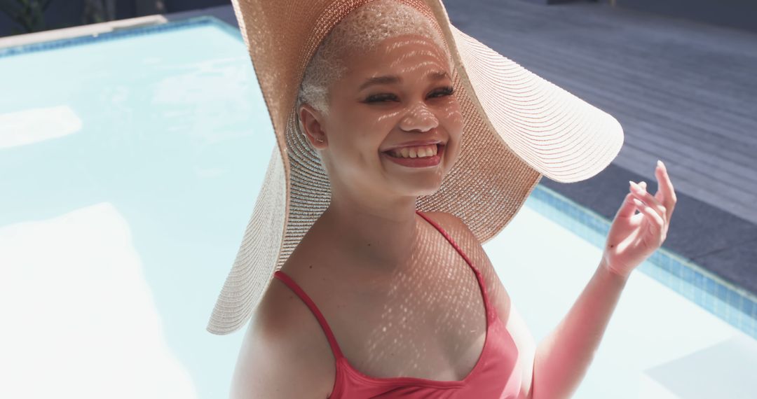 Happy Woman in Sun Hat Relaxing by Poolside on Sunny Day - Free Images, Stock Photos and Pictures on Pikwizard.com