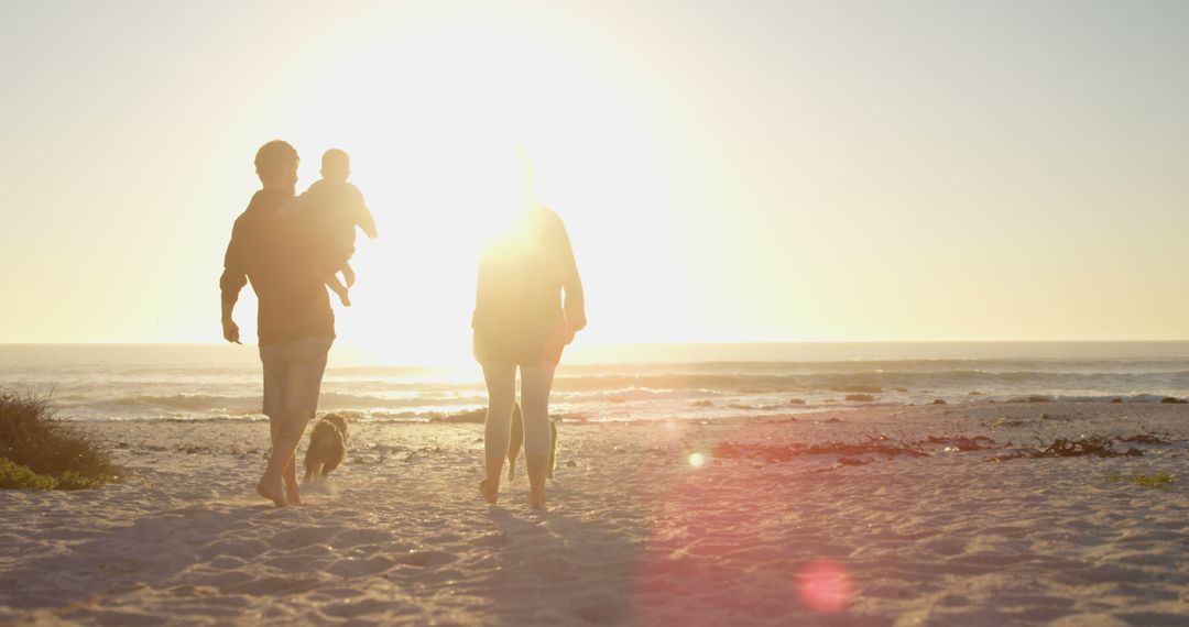 Young Family Walking on Sandy Beach at Sunset - Free Images, Stock Photos and Pictures on Pikwizard.com