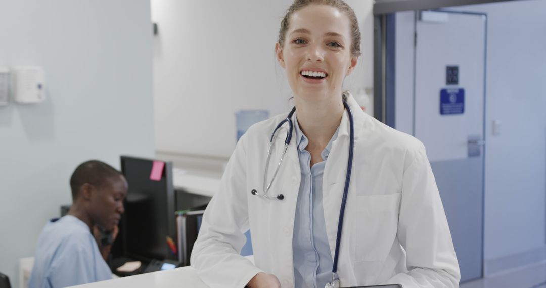 Smiling Female Doctor at Reception Desk in Hospital - Free Images, Stock Photos and Pictures on Pikwizard.com