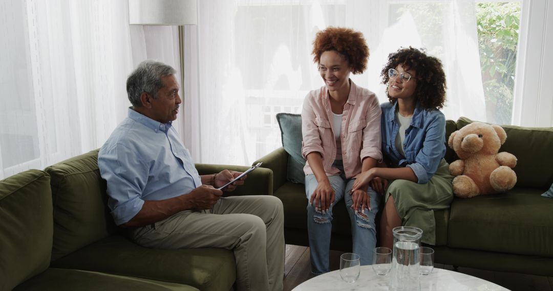 Multigenerational diverse family sharing warm conversation on green sofa