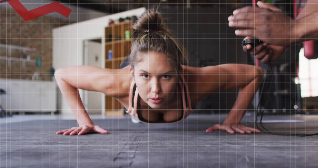 Female Athlete Performing Plank Exercise Being Timed Using Stopwatch
