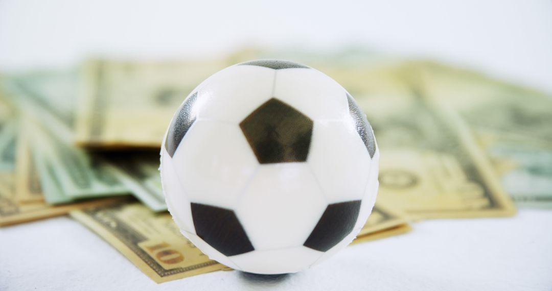 Soccer Ball with Stack of Money, Symbolizing Sports Betting or Financial Investment - Free Images, Stock Photos and Pictures on Pikwizard.com