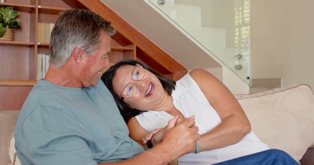 Senior Couple Relaxing on Sofa, Embracing Comfort and Joy