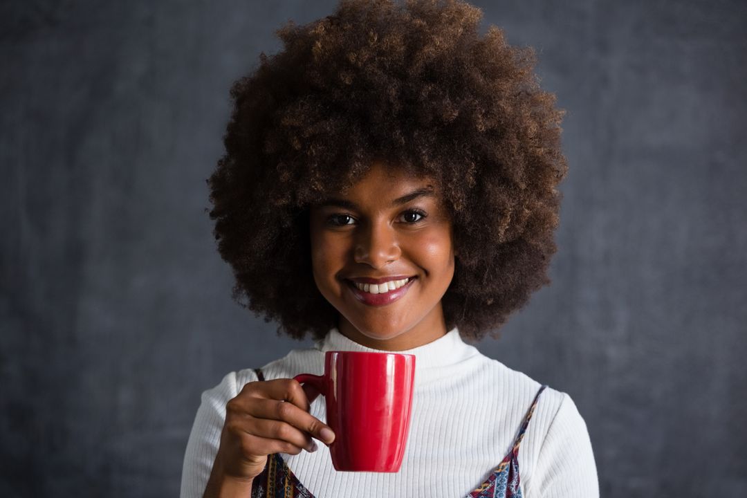 Smiling Woman with Frizzy Hair Holding Red Coffee Mug - Free Images, Stock Photos and Pictures on Pikwizard.com